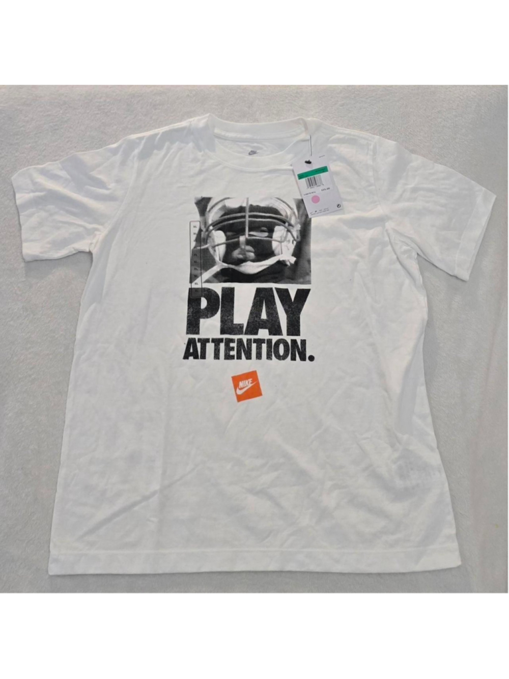 Nike Play Attention white t-shirt with black graphic of a person in a helmet wit